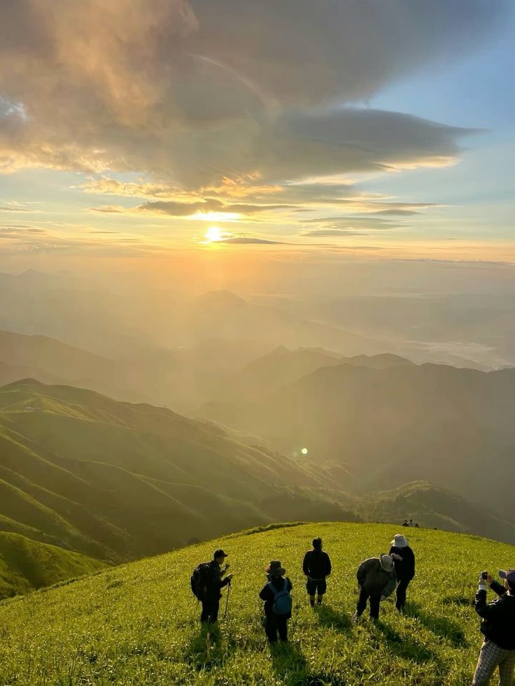 Hikers resting in lush greenery while enjoying the warm sunlight.